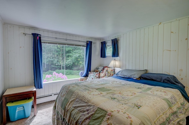 bedroom featuring baseboard heating and carpet