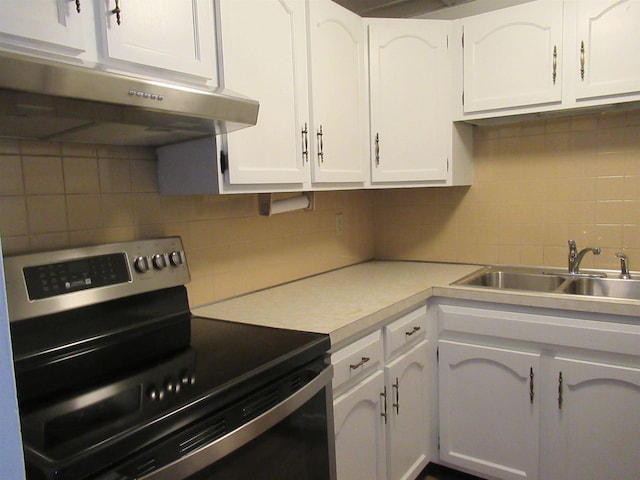 kitchen with sink, electric range, white cabinets, and backsplash