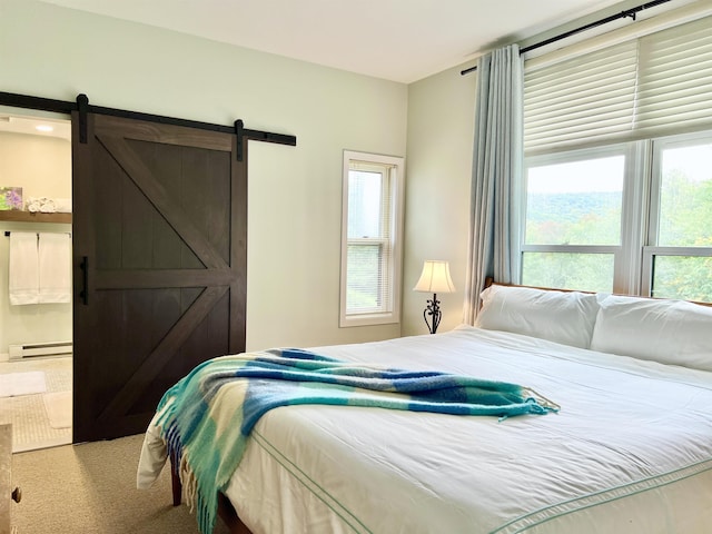 bedroom with carpet floors, a baseboard radiator, and a barn door