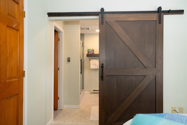 hallway featuring a baseboard heating unit and a barn door