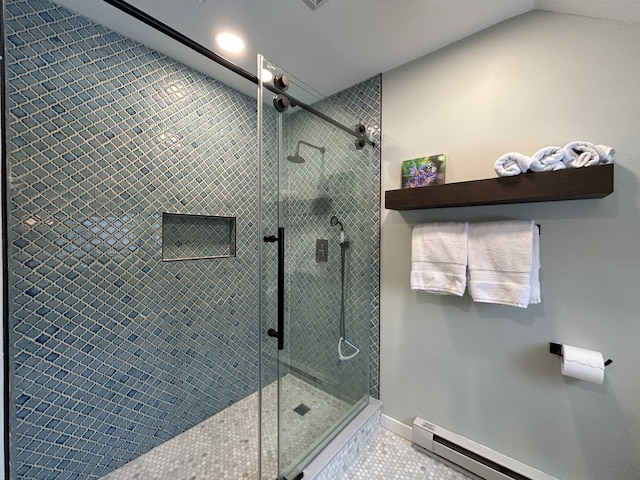 bathroom featuring an enclosed shower, a baseboard heating unit, tile patterned floors, and lofted ceiling