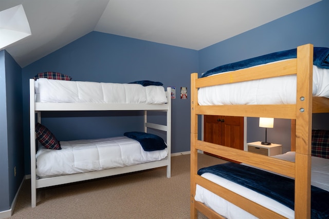 bedroom featuring carpet and lofted ceiling