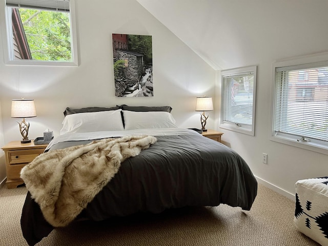 bedroom featuring multiple windows, carpet floors, and lofted ceiling