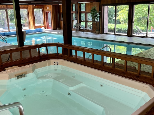 view of swimming pool with an indoor hot tub