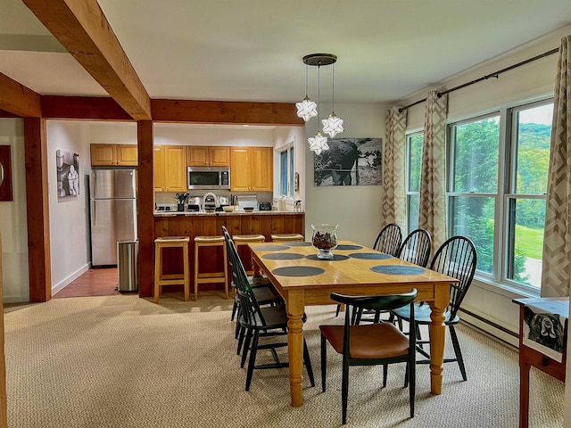 carpeted dining space featuring baseboard heating and beam ceiling