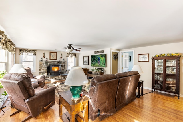 living room featuring a wealth of natural light, light hardwood / wood-style floors, and ceiling fan