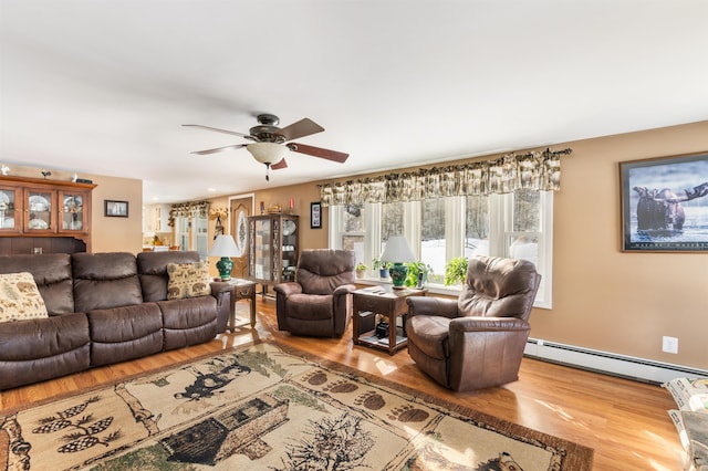 living room featuring a baseboard radiator, wood-type flooring, and ceiling fan