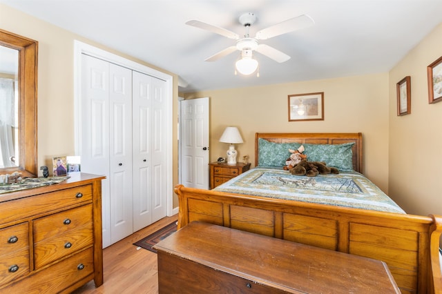 bedroom featuring ceiling fan, a closet, and light hardwood / wood-style flooring