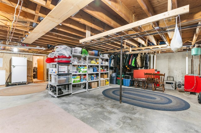 basement featuring white fridge