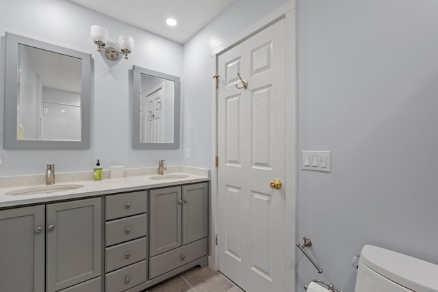 bathroom featuring tile patterned floors, vanity, and toilet