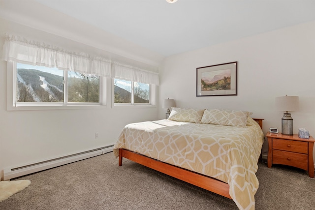 carpeted bedroom with a baseboard radiator and a mountain view