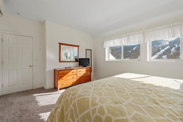 carpeted bedroom with lofted ceiling