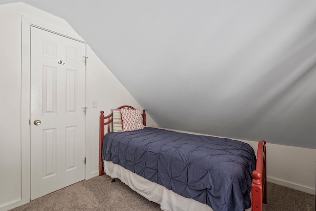 carpeted bedroom with vaulted ceiling