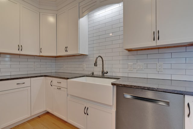 kitchen featuring white cabinetry, dishwasher, sink, and dark stone countertops