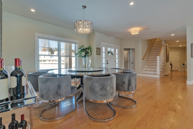 dining area featuring a notable chandelier and light hardwood / wood-style floors