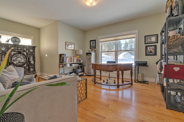 home office with light hardwood / wood-style floors