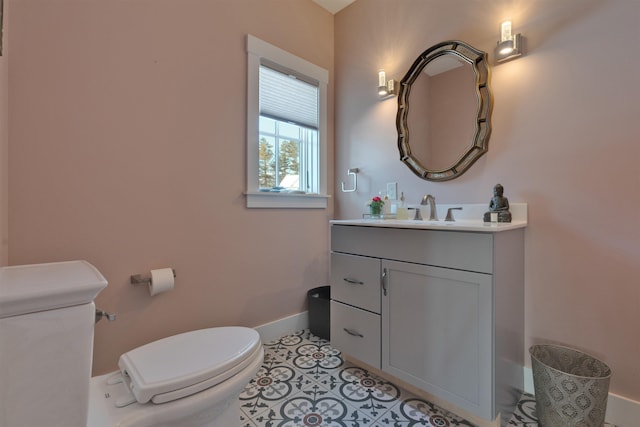 bathroom featuring vanity, tile patterned floors, and toilet