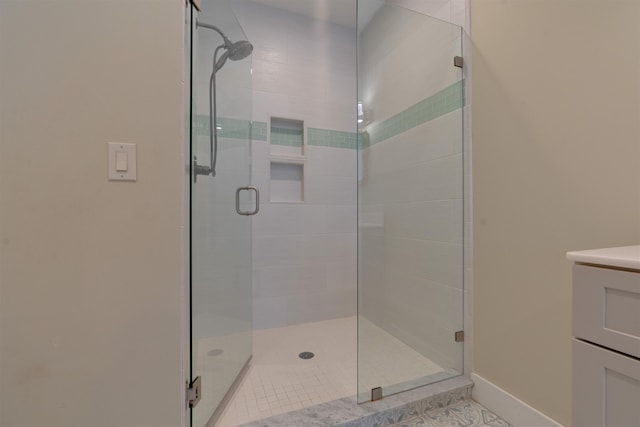 bathroom with vanity and a shower with shower door