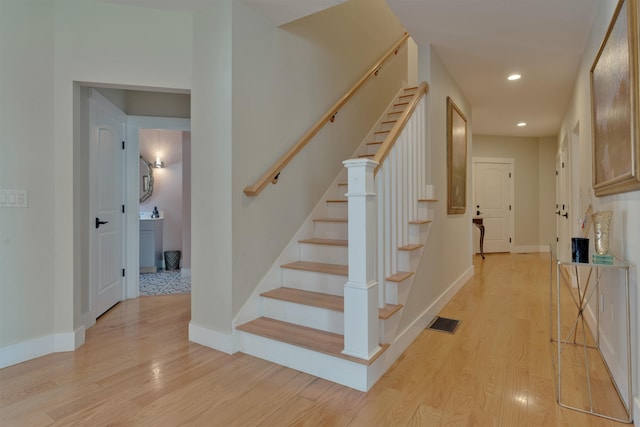 stairs featuring hardwood / wood-style flooring