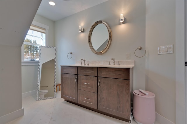 bathroom featuring vanity and toilet