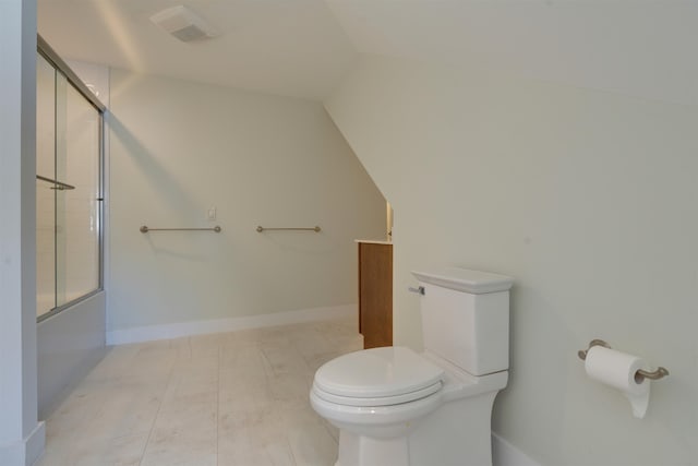 bathroom featuring bath / shower combo with glass door and toilet