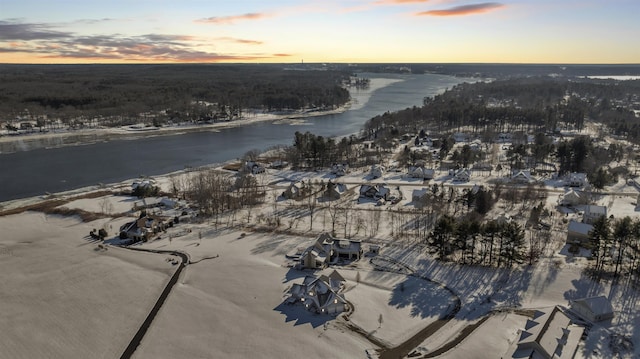 snowy aerial view with a water view