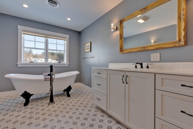 bathroom with a washtub and vanity