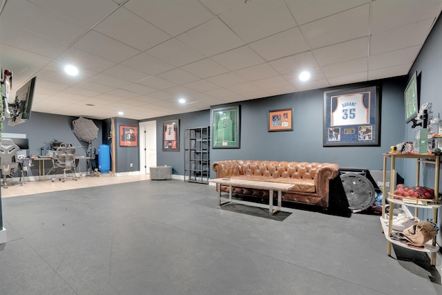 interior space with a paneled ceiling and concrete floors