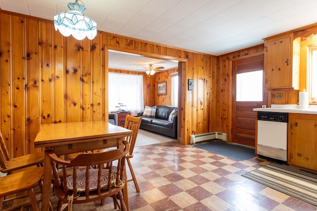 dining space with wooden walls and baseboard heating