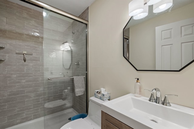 bathroom featuring walk in shower, vanity, and toilet