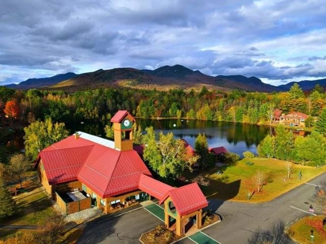 75 Riverfront Dr Unit 206, Woodstock, NH 03262 - aerial view of a water and mountain view and a heavily wooded area