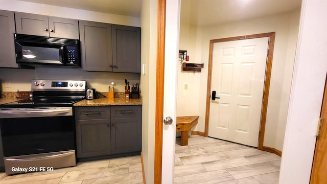 kitchen with stainless steel range with electric cooktop and stone counters