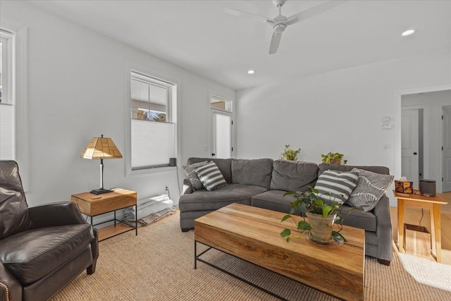 living room featuring ceiling fan and light hardwood / wood-style flooring