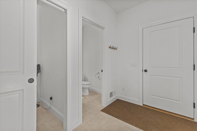 bathroom featuring tile patterned floors and toilet