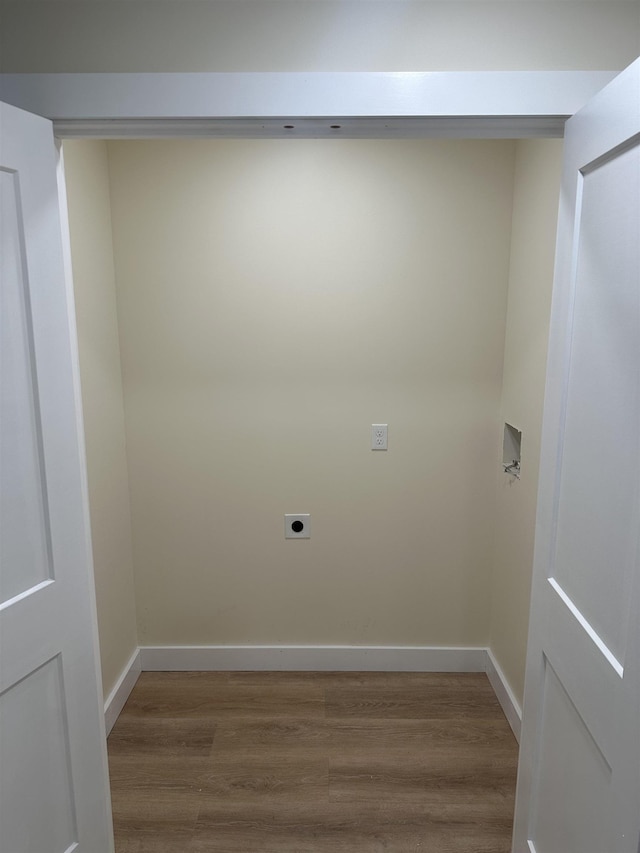 laundry area featuring wood-type flooring and electric dryer hookup