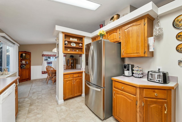 kitchen featuring light tile patterned flooring, dishwasher, and stainless steel fridge with ice dispenser