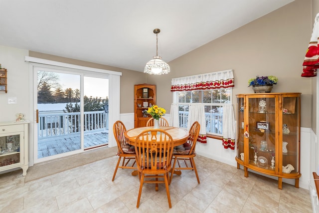 dining area featuring lofted ceiling and light tile patterned floors