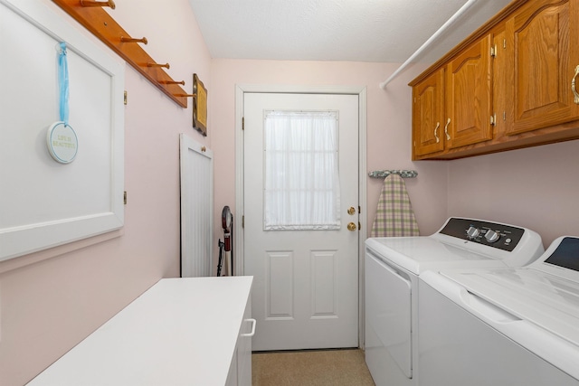 washroom featuring cabinets and independent washer and dryer