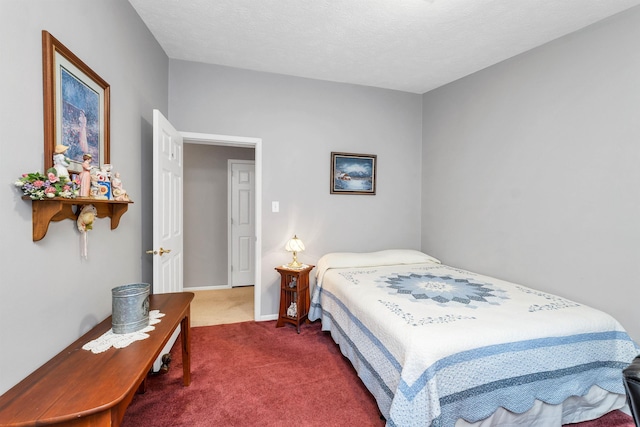 carpeted bedroom with a textured ceiling