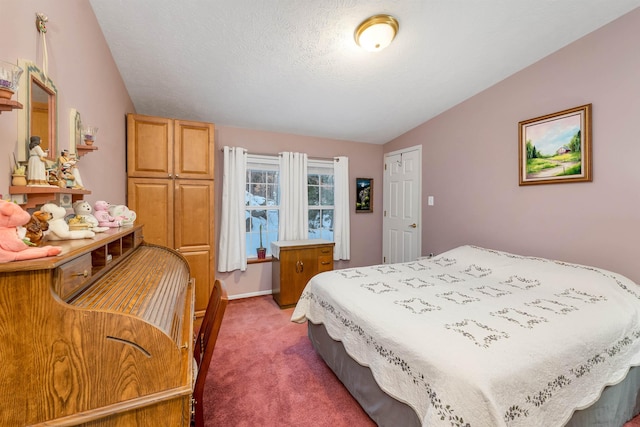 bedroom with lofted ceiling, a textured ceiling, and dark carpet