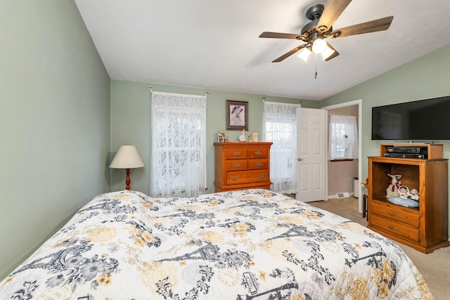 carpeted bedroom featuring vaulted ceiling and ceiling fan