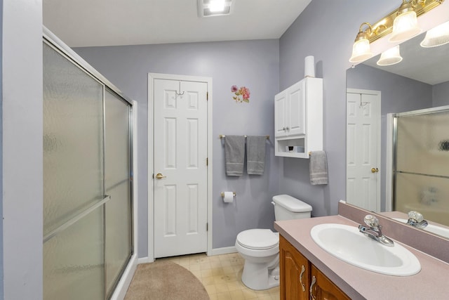 bathroom with vanity, toilet, and walk in shower