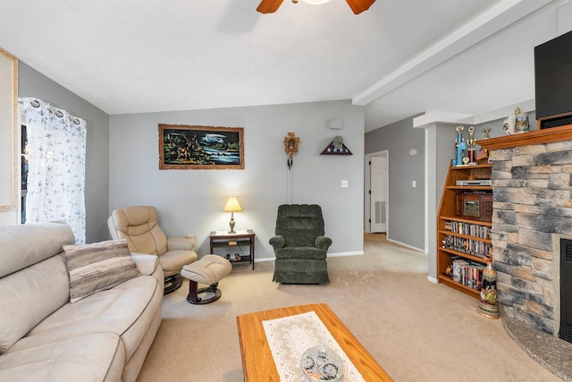 living room with light carpet, a stone fireplace, lofted ceiling with beams, and ceiling fan