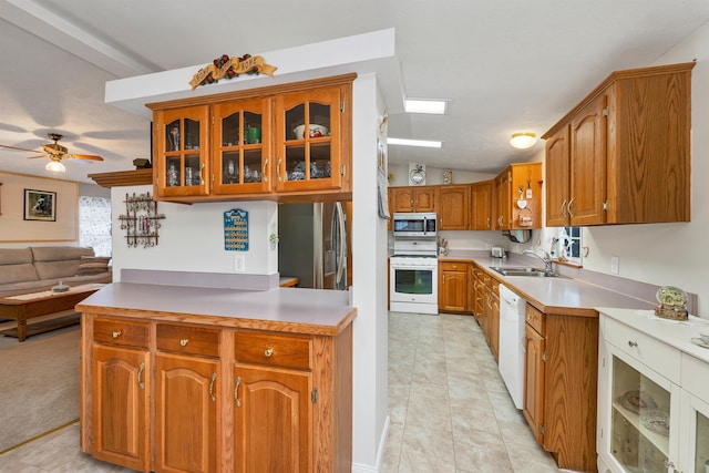 kitchen featuring lofted ceiling, sink, light tile patterned floors, ceiling fan, and stainless steel appliances