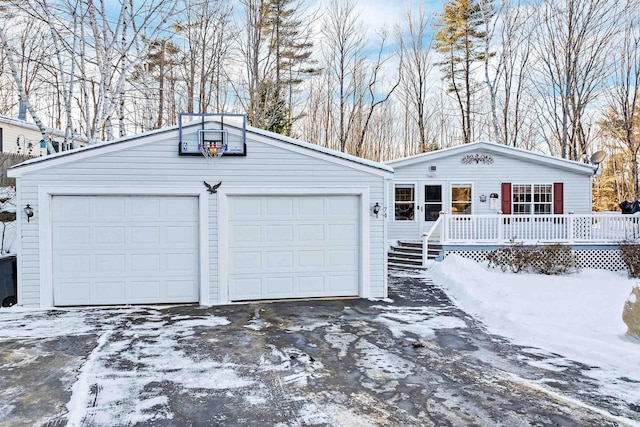 ranch-style home with a garage and a deck