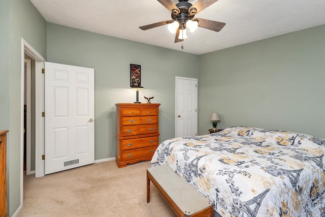 bedroom with light carpet and ceiling fan