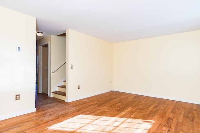 empty room with hardwood / wood-style floors