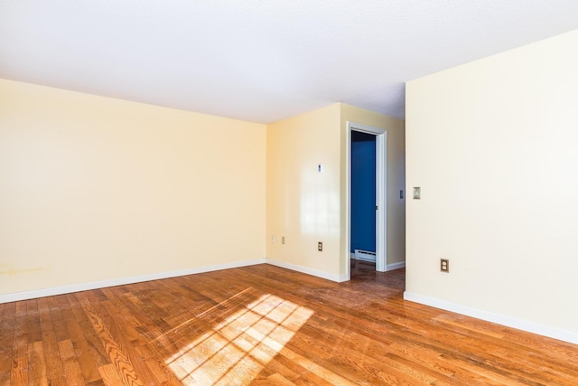 empty room with hardwood / wood-style flooring