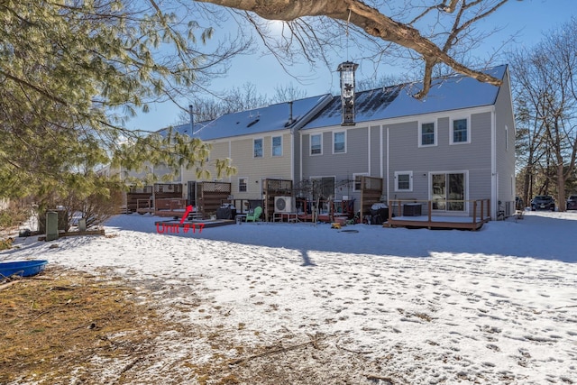 view of snow covered back of property