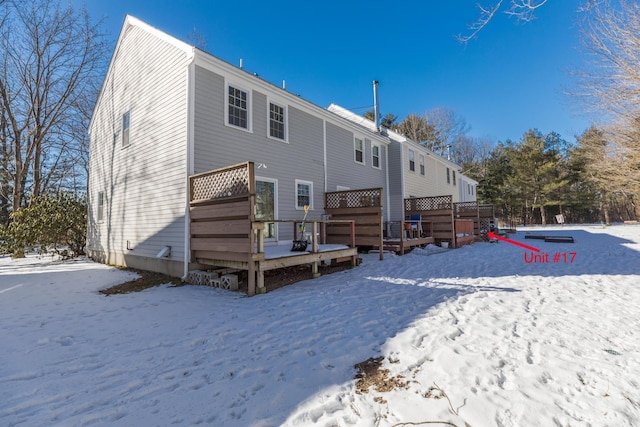 snow covered property featuring a deck